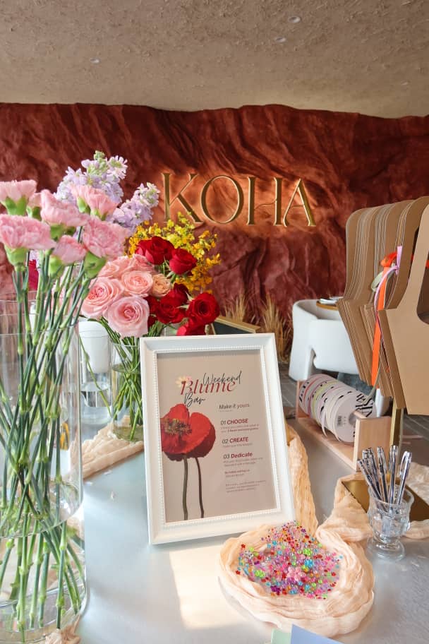The Weekend Blume Bar display with fresh flowers, bouquet carriers and personal message details at KOHA Bistro.