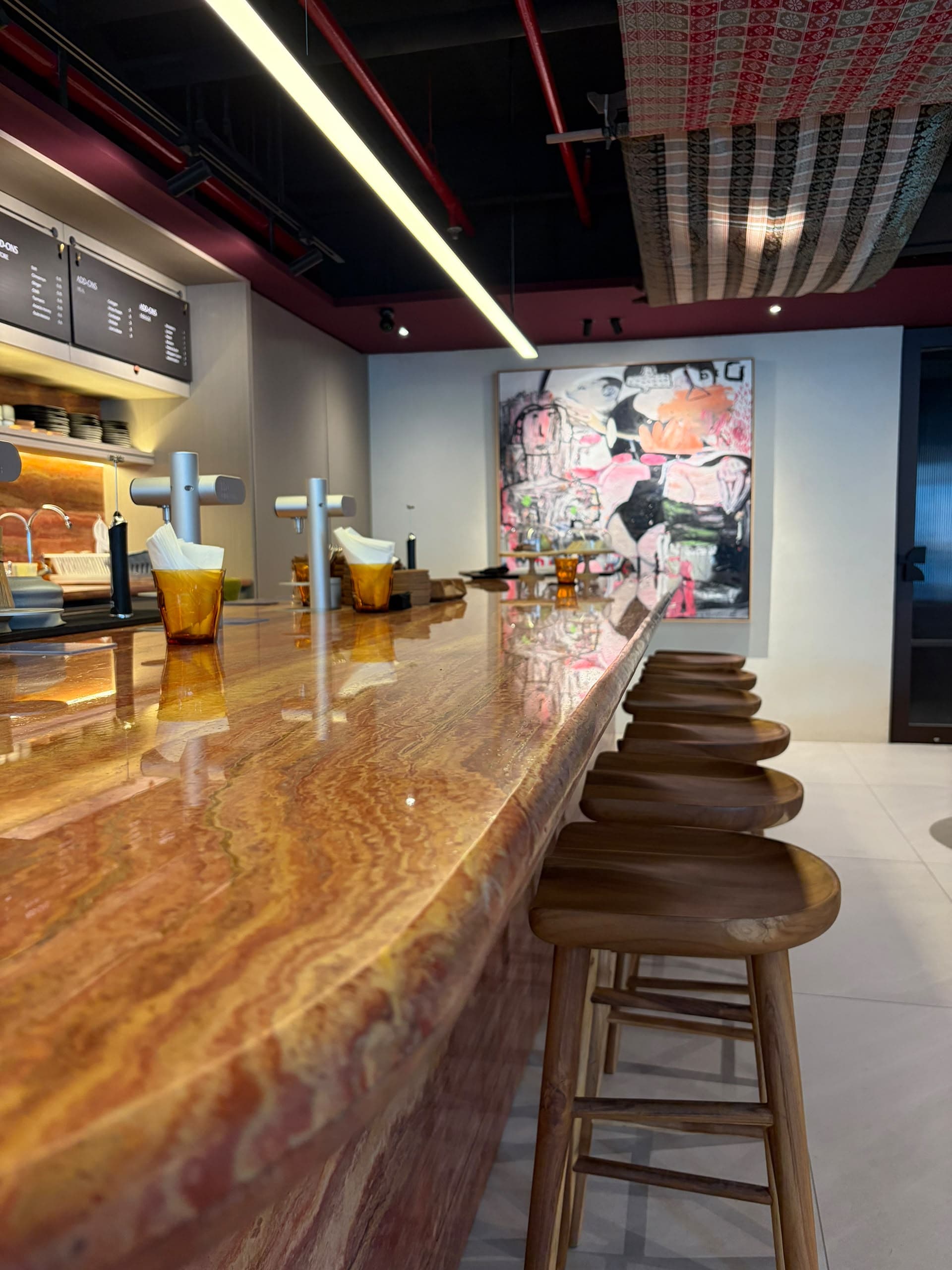 The long cacao bar and warm interior at Kakao Origin in Kuala Lumpur